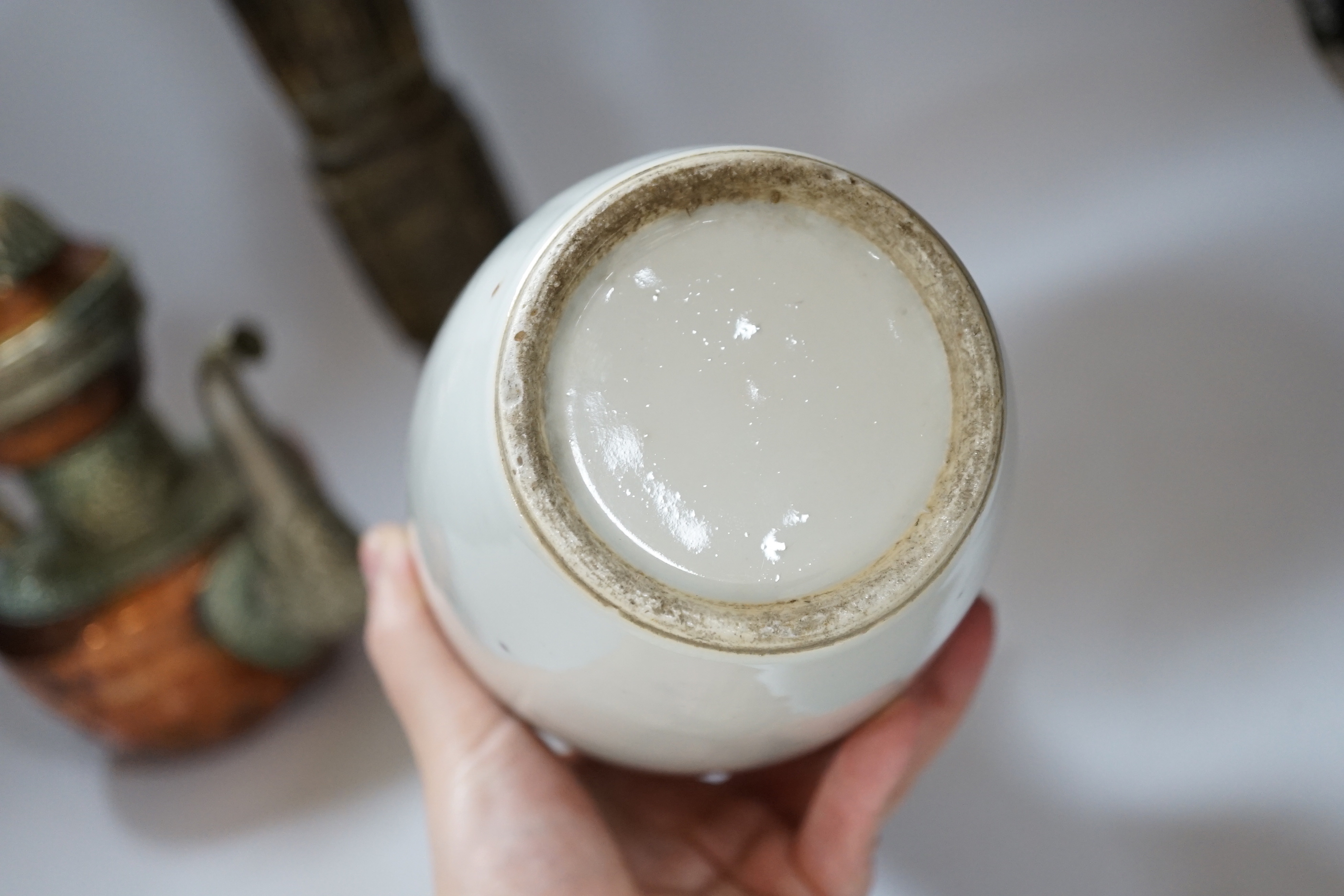 A Chinese bronze gu vase, a 19th century Chinese blue and white vase and a Tibetan teapot, tallest 34cm